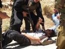 _imemc_org_cache_imagecache_local_attachments_oct2007_400_0___10000000_0_0_0_0_0_iyad_bornat_being_attacked_by_israeli_soldiers_during_bilin_protest__file_2007.jpg